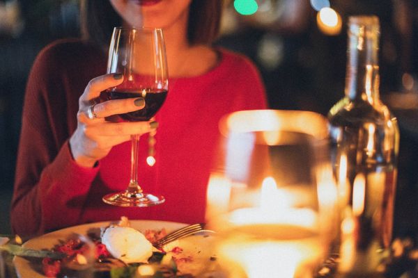 woman holding wine glass selective focus photography 1850595