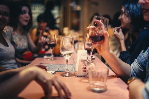 people drinking liquor and talking on dining table close up 696218