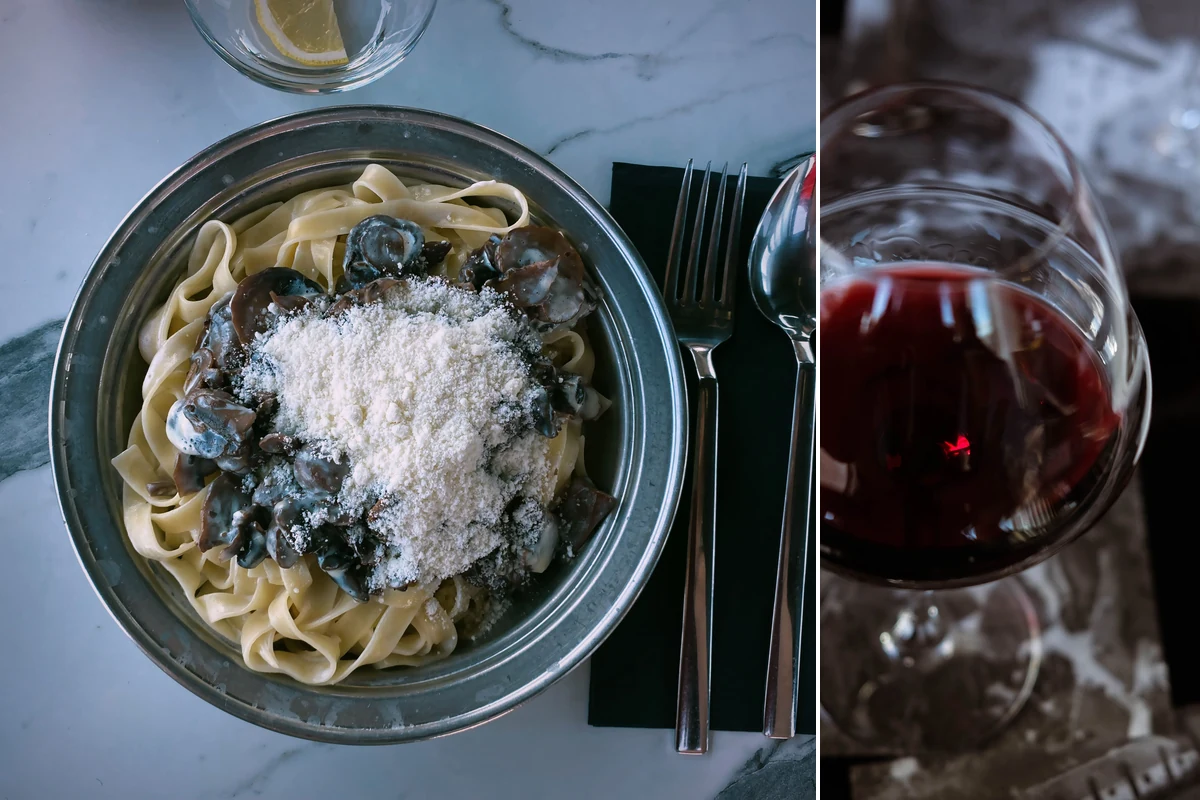Fettuccine com cogumelos e taça de vinho tinto em composição editorial para harmonizar com Finca Patagonia Pinot Noir